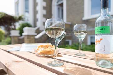 There is a patio area to the front of the property, and just across the road is the beach.
