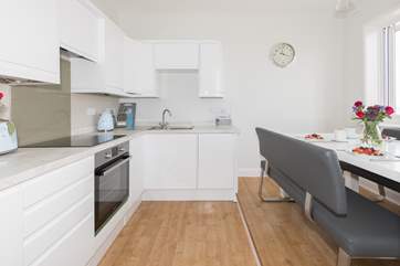 The modern and well-equipped kitchen/diner is a lovely place for entertaining with family and friends.