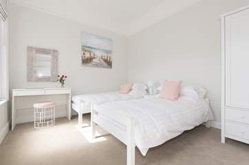 The very pretty twin bedroom has plenty of space for two.