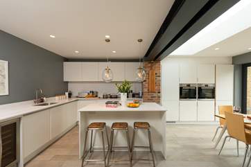 The sleek contemporary kitchen is a delight to use and is exceptionally well equipped.