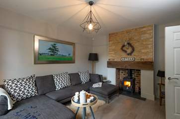 The welcoming living room is perfect for relaxing by the wood burning stove.