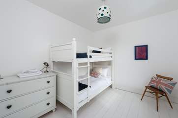 The fourth bedroom has 3ft bunk beds and a cool white decor. This bedroom is on the first floor.