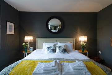 Luxurious bed linens and soothing wall colours make this spacious bedroom a delight to go to bed in !