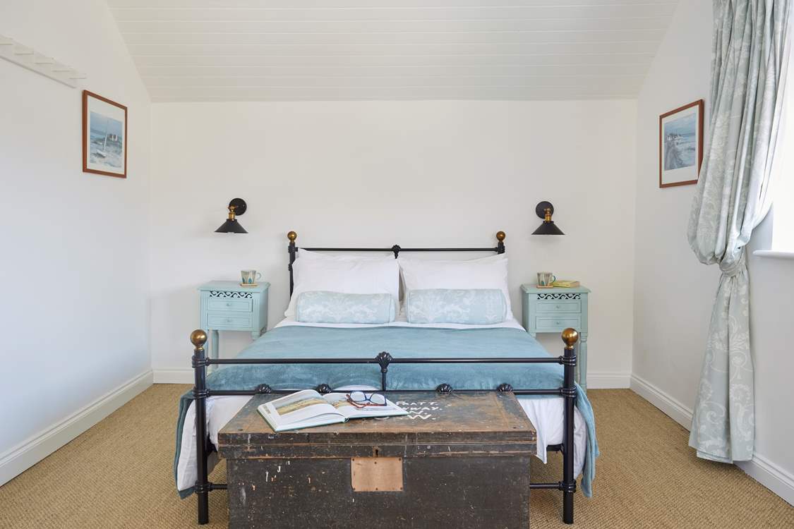 The lovely hues of blue give double bedroom one on the first floor a tranquil feel.