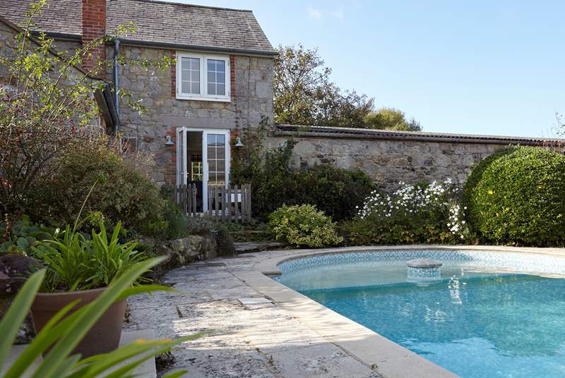 The secure gate, seen open by the living room French doors leads to the gorgeous pool area, secure for your little guests.