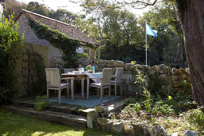 A Mediterranean-style dining terrace made with re-claimed sleepers in the front garden.
