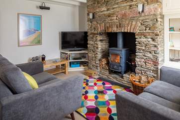 The sitting-room is cute and cosy and links through to the kitchen and dining area.