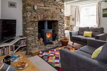 The glowing wood-burner really sets off this cosy sitting-room.