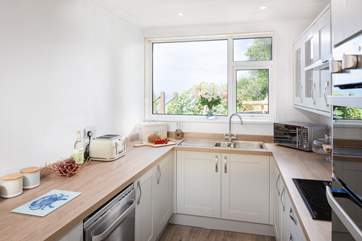 The Shaker-style kitchen is very well-equipped.