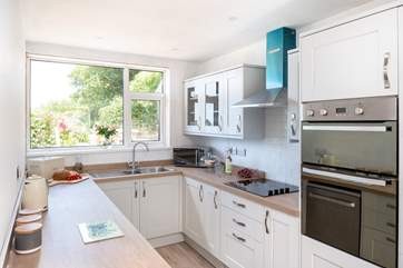 The kitchen has plenty of work surfaces and cupboards.