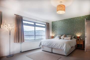 Bedroom 1 offers a fantastic space with water views and boasts a super-king sized bed.
