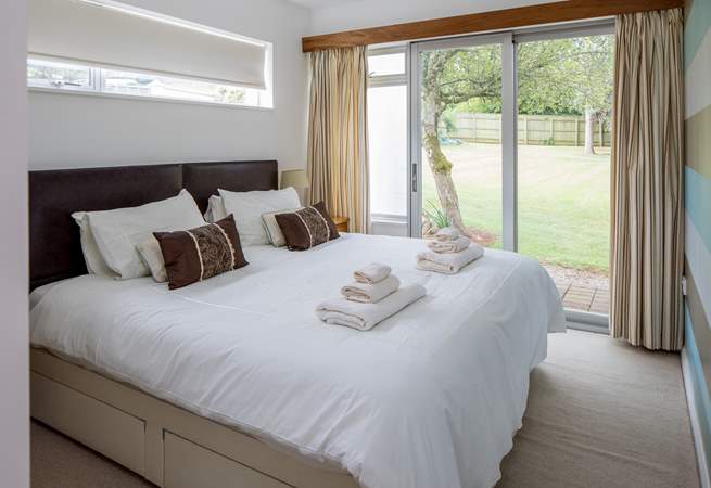 Bedroom three also offers a super-king size bed which can be configured as two single beds. You also have direct access to the lawn area via the patio door.