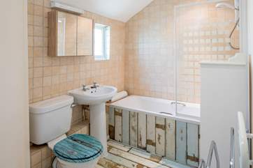 The family bathroom has a bath and over head shower.