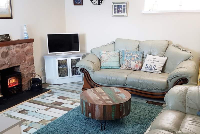 Such a comfy and welcoming living space to cosy up in after a day of adventure, especially with the wood-burner effect electric stove.