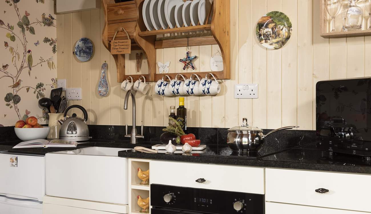 The kitchen is well-equipped and includes an electric oven and induction hob, perfect for rustling up supper.