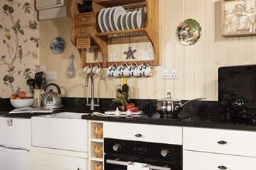 The kitchen is well-equipped and includes an electric oven and induction hob, perfect for rustling up supper.