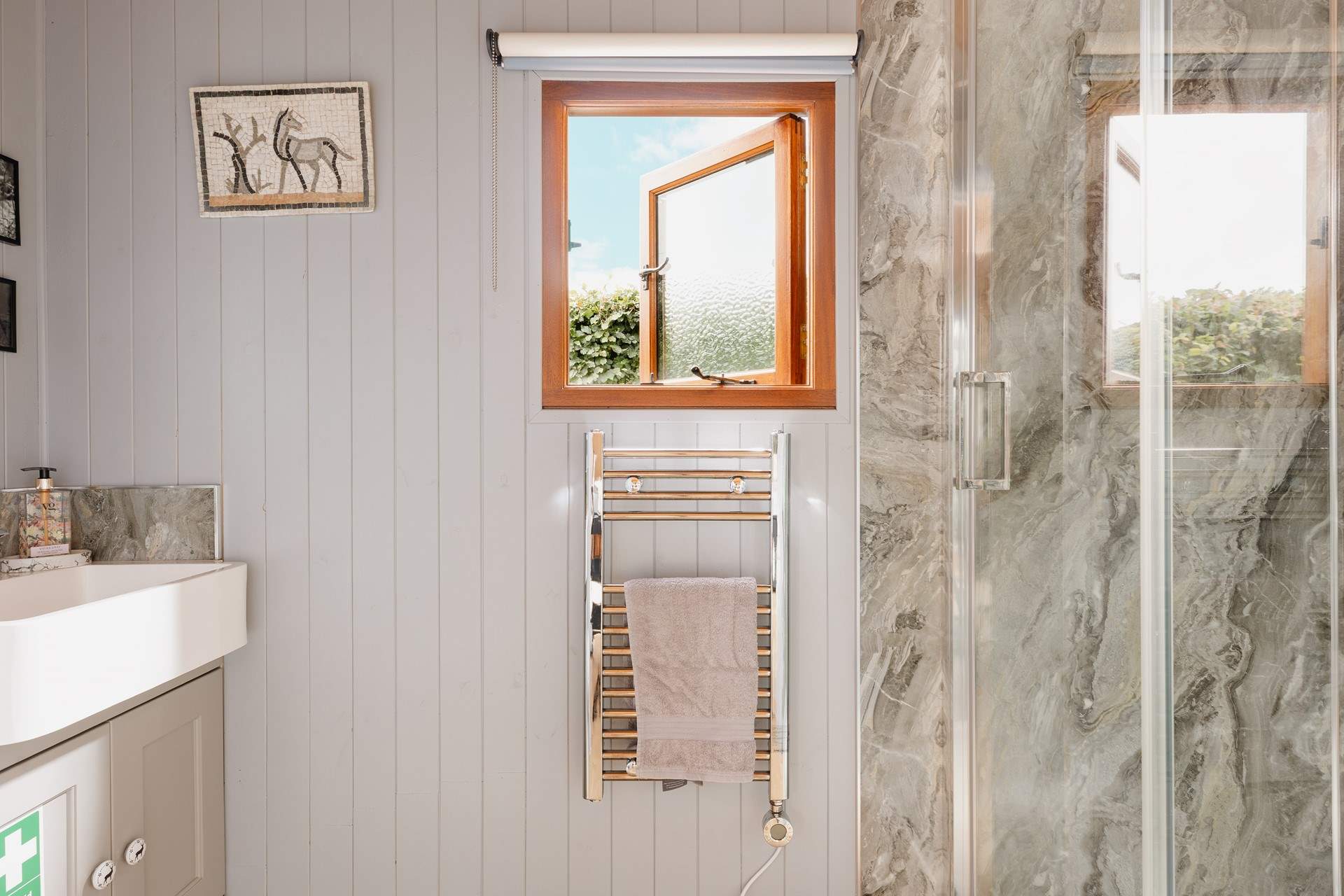 You'll find the sleek shower- room just beyond the kitchen. 