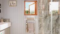 You'll find the sleek shower- room just beyond the kitchen. 