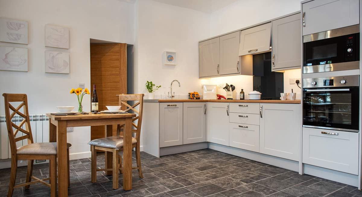 Serving up meals will be a doddle with the dining-table situated next to the kitchen.