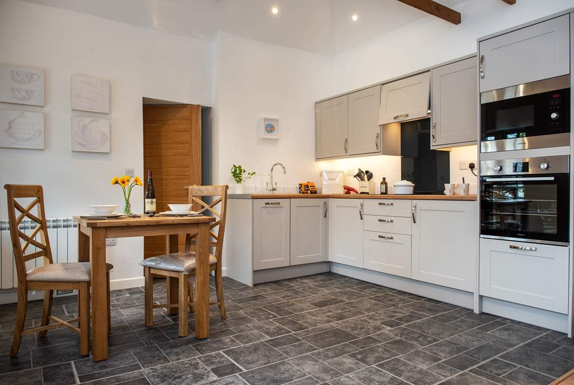 Serving up meals will be a doddle with the dining-table situated next to the kitchen.