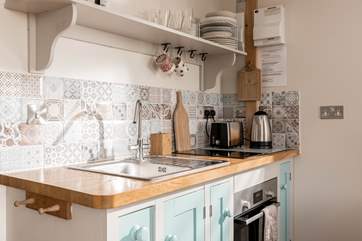 The sweetest kitchenette, with an array of beautiful tiles.