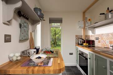 The kitchen area is well-equipped with all you could need for a comfortable stay.