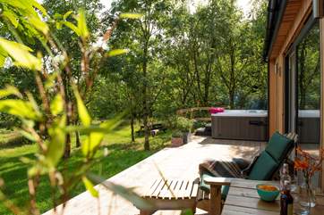 The deck with loungers soaking up the sunshine and enjoying the fabulous views tucked away next to the woodland.