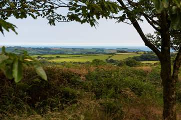 There are stunning far-reaching views over countryside out to the sea in the distance.