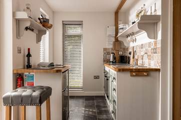 The superbly equipped kitchen, decorated with an array of stunning tiles.