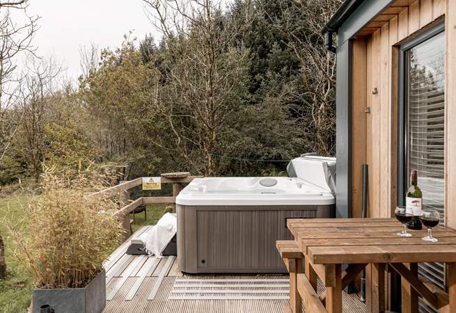 With a lovely decking hosting the luxurious hot tub.