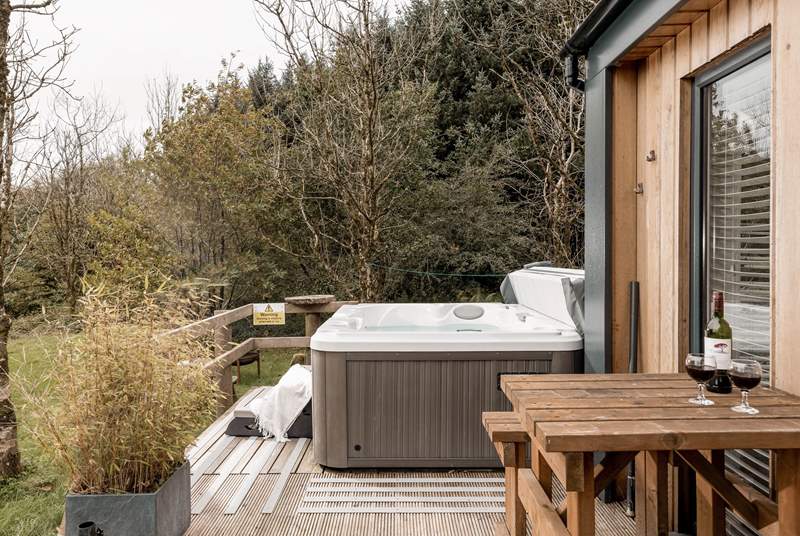 With a lovely decking hosting the luxurious hot tub.