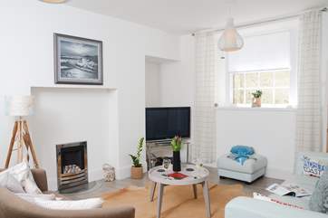 The comfortable sitting-room is spacious and light.