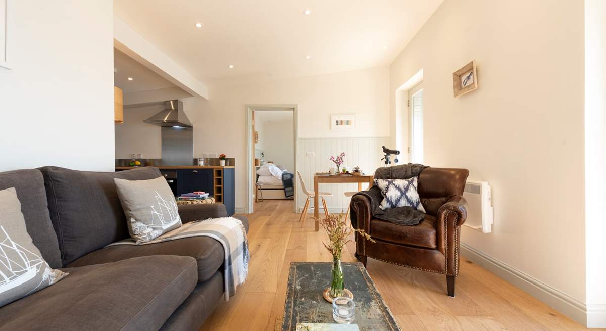 The entrance leads straight into the sitting-area, with the kitchen and bedroom beyond.