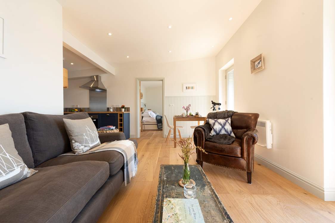 The entrance leads straight into the sitting-area, with the kitchen and bedroom beyond.