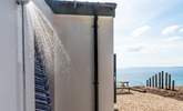 The outdoor shower is ideal for rinsing off sandy dogs and bodies. - Thumbnail Image