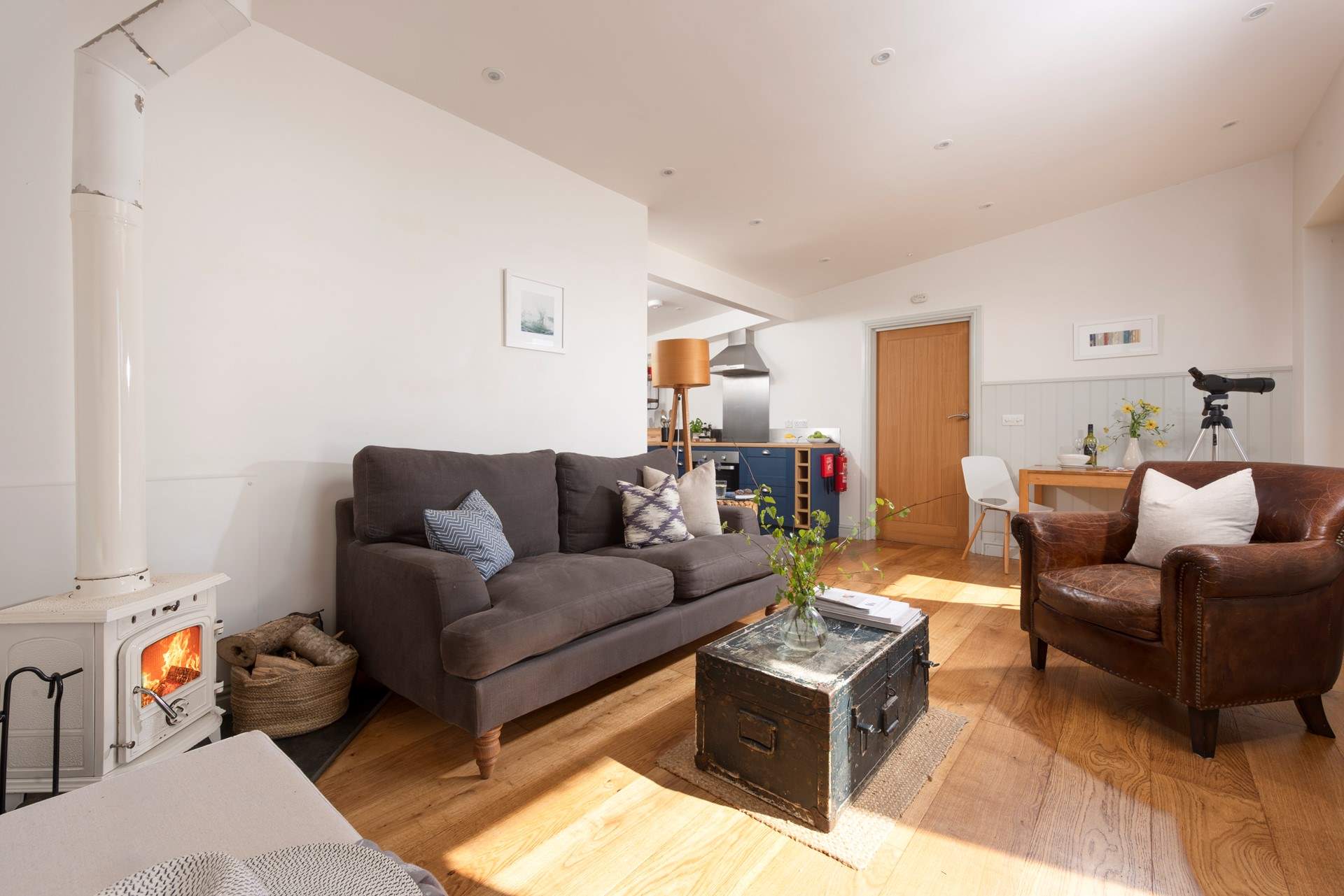 The entrance leads straight into the sitting-area, with the kitchen and bedroom beyond.