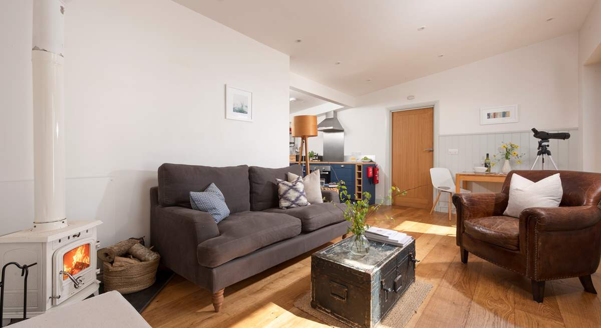 The entrance leads straight into the sitting-area, with the kitchen and bedroom beyond.