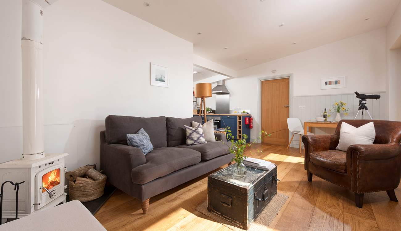 The entrance leads straight into the sitting-area, with the kitchen and bedroom beyond.