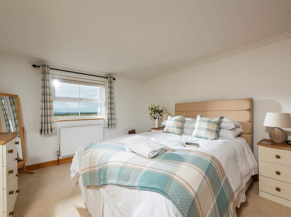 The spacious main bedroom with sea views and an en suite shower-room.