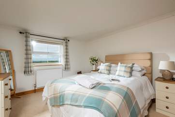 The spacious master bedroom with sea views and an en suite shower-room.