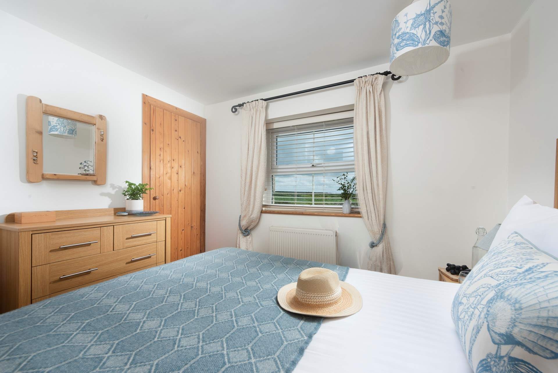 Countryside views from this classy, nautical bedroom.