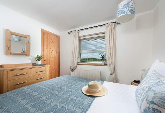 Countryside views from this classy, nautical bedroom.