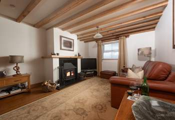 The stylish sitting-room with characterful beams.