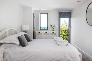 The master bedroom with sea views has a little door leading out onto the balcony.