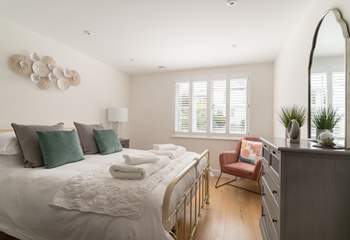 That main bedroom is beautifully styled in relaxing pale pinks and soft creams.