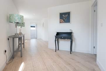 Access to the downstairs bedrooms is from a staircase in the entrance hallway.