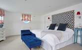 The main bedroom has a super-king bed and en suite bathroom with bath and shower cubicle.  - Thumbnail Image