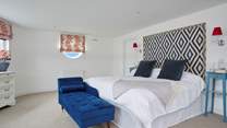 The main bedroom has a super-king bed and en suite bathroom with bath and shower cubicle. 