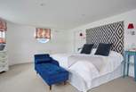 The main bedroom has a super-king bed and en suite bathroom with bath and shower cubicle. 