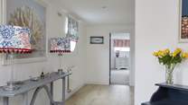 Access to the downstairs bedrooms is from a staircase in the entrance hallway.